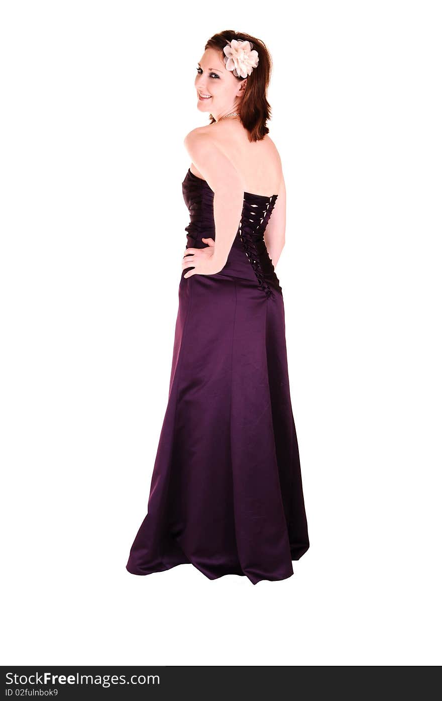 An beautiful young woman in an burgundy long evening gown standing in the 
studio, looking over her shoulder for white background. An beautiful young woman in an burgundy long evening gown standing in the 
studio, looking over her shoulder for white background.