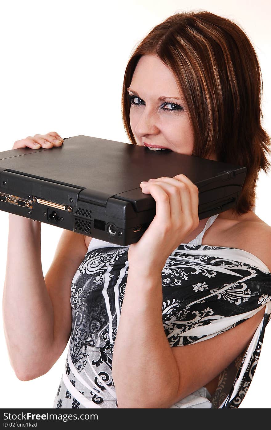 A young woman in a white black dress is very angry at her laptop und
like to bite the computer so that he is working again, for white background. A young woman in a white black dress is very angry at her laptop und
like to bite the computer so that he is working again, for white background.