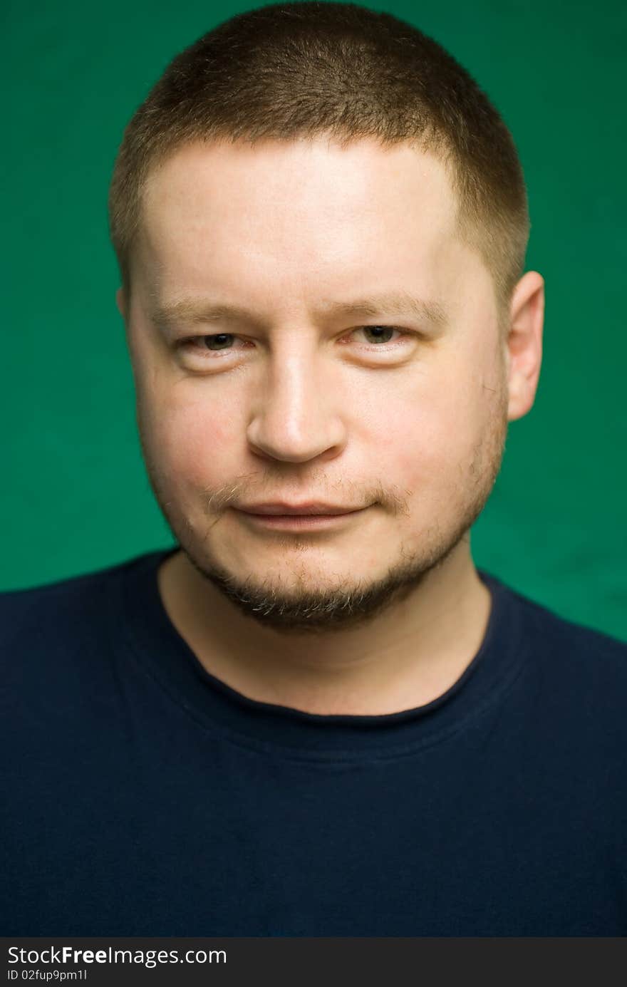 Portrait of the man on green background.