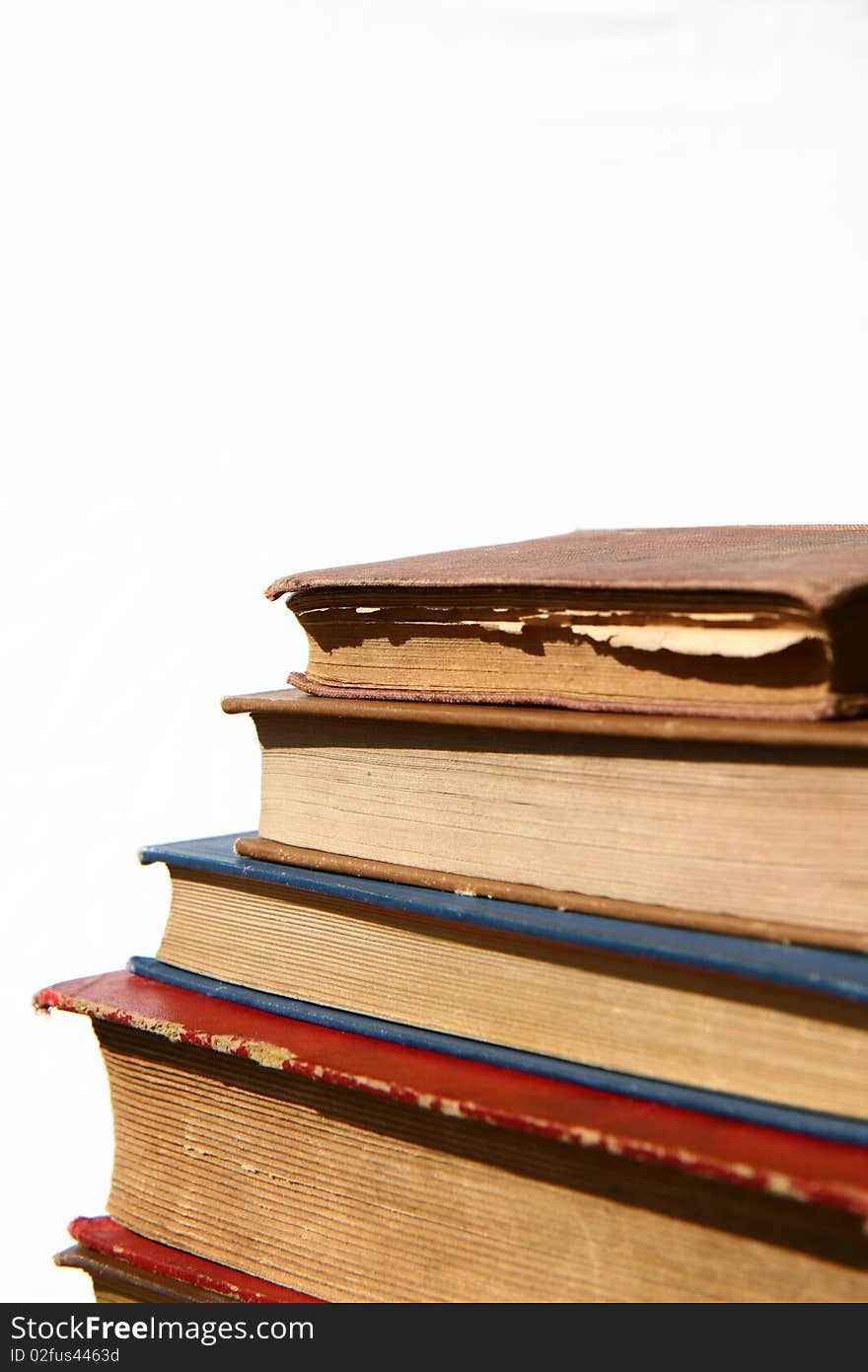 Stack of old books on white background