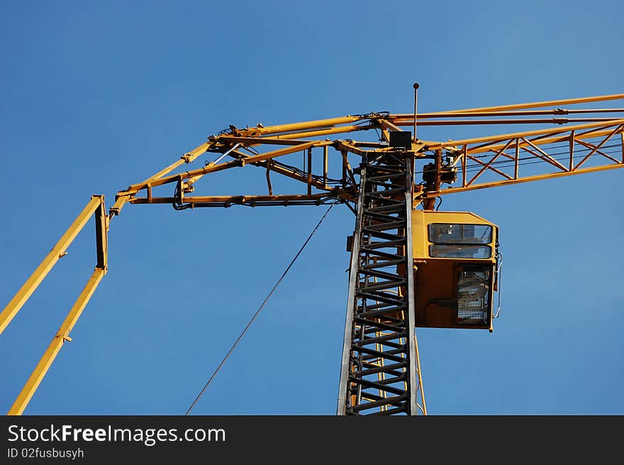 A construction crane with a blue sky. A construction crane with a blue sky