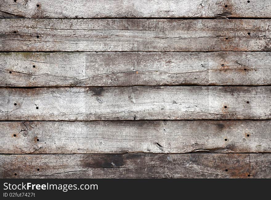 Old wall, made of horizontal wooden planks.