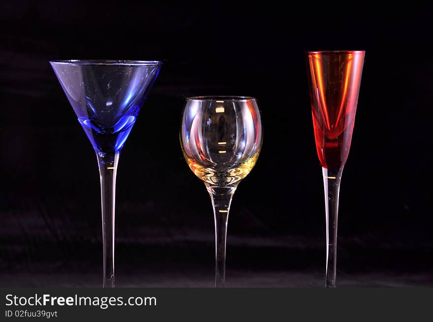3 drink glasses in primary colors, black. 3 drink glasses in primary colors, black