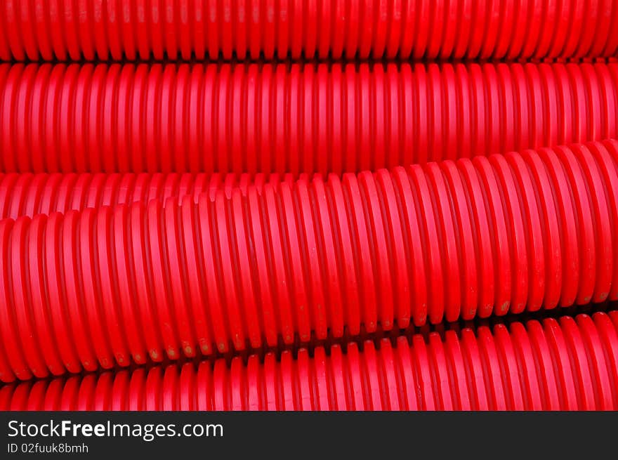 Red plastic pipes at a construction site