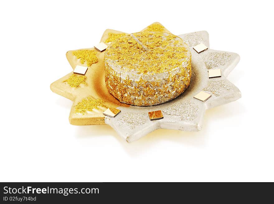 Ceramic candle holder with a candle in the form of the sun with sparkles isolated on a white background. Ceramic candle holder with a candle in the form of the sun with sparkles isolated on a white background