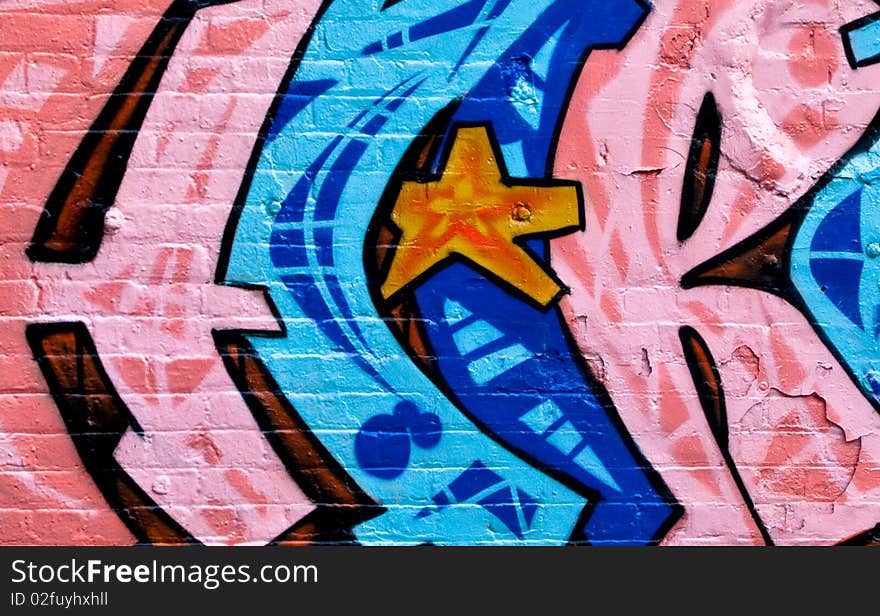 Segment of graffiti on an air duct on the side of a derelict building