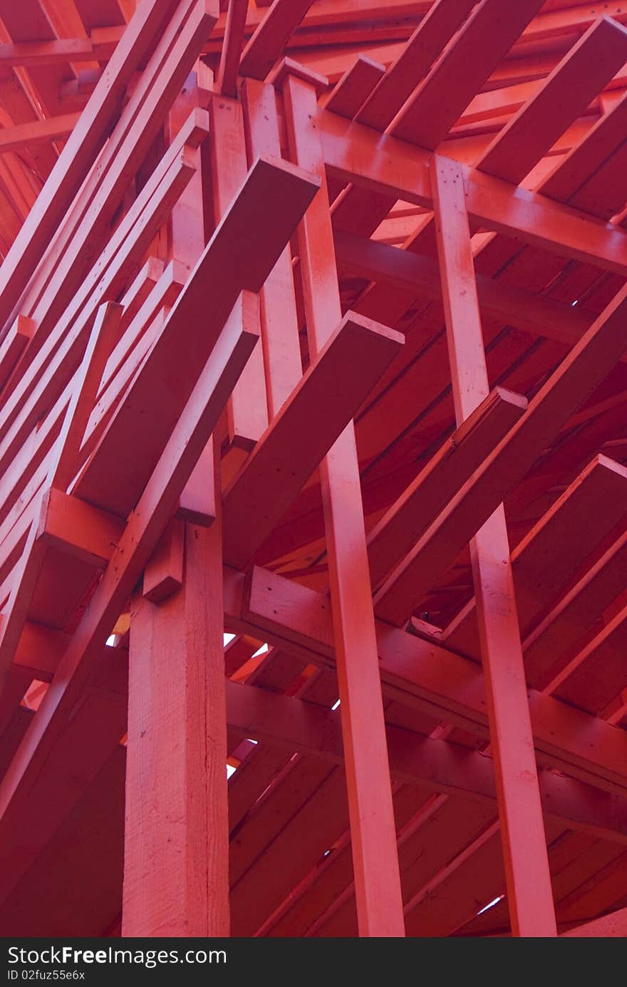 Red blocks of wood put together in a moder architechtural design. Red blocks of wood put together in a moder architechtural design