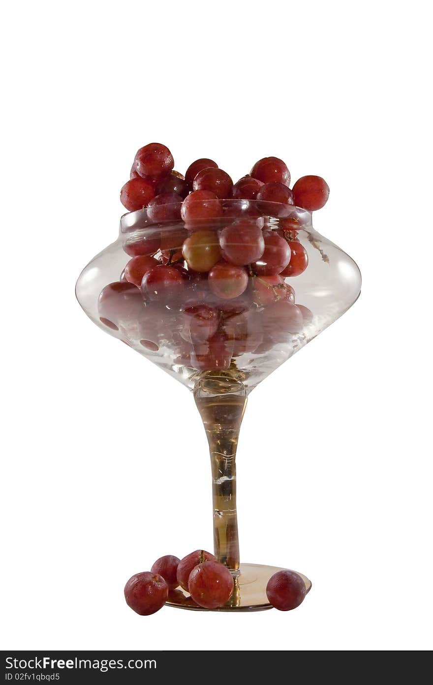 Fresh red grapes in clear crystal bowl on a white background. Fresh red grapes in clear crystal bowl on a white background.