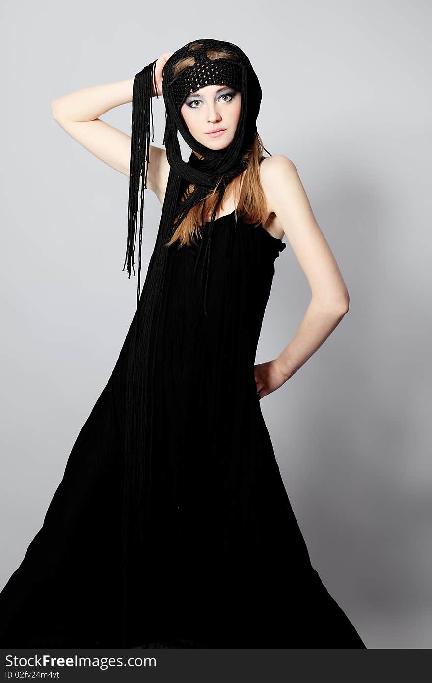 Portrait of a beautiful girl in elegant black dress. Shot in a studio. Portrait of a beautiful girl in elegant black dress. Shot in a studio.