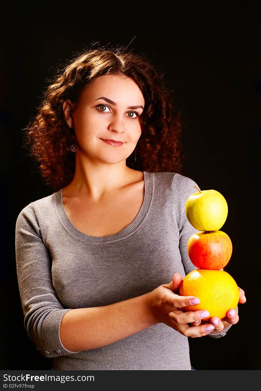 Portrait of a young woman with apples and grapefruit. Studio shot. Portrait of a young woman with apples and grapefruit. Studio shot.