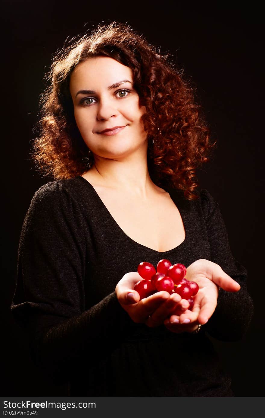 Portrait of young beautiful woman with grapes on her hands. Portrait of young beautiful woman with grapes on her hands.