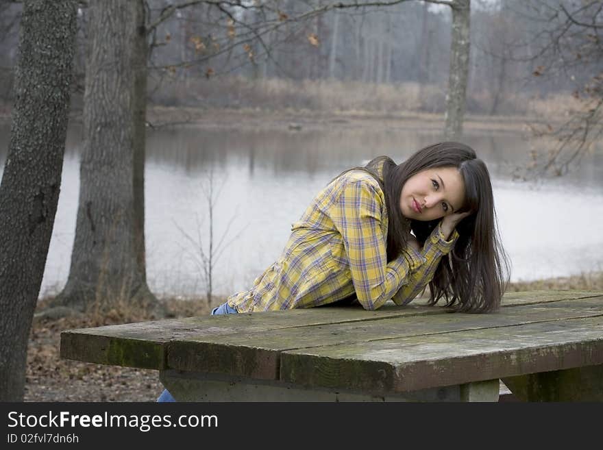 Woman leaning on picnic table