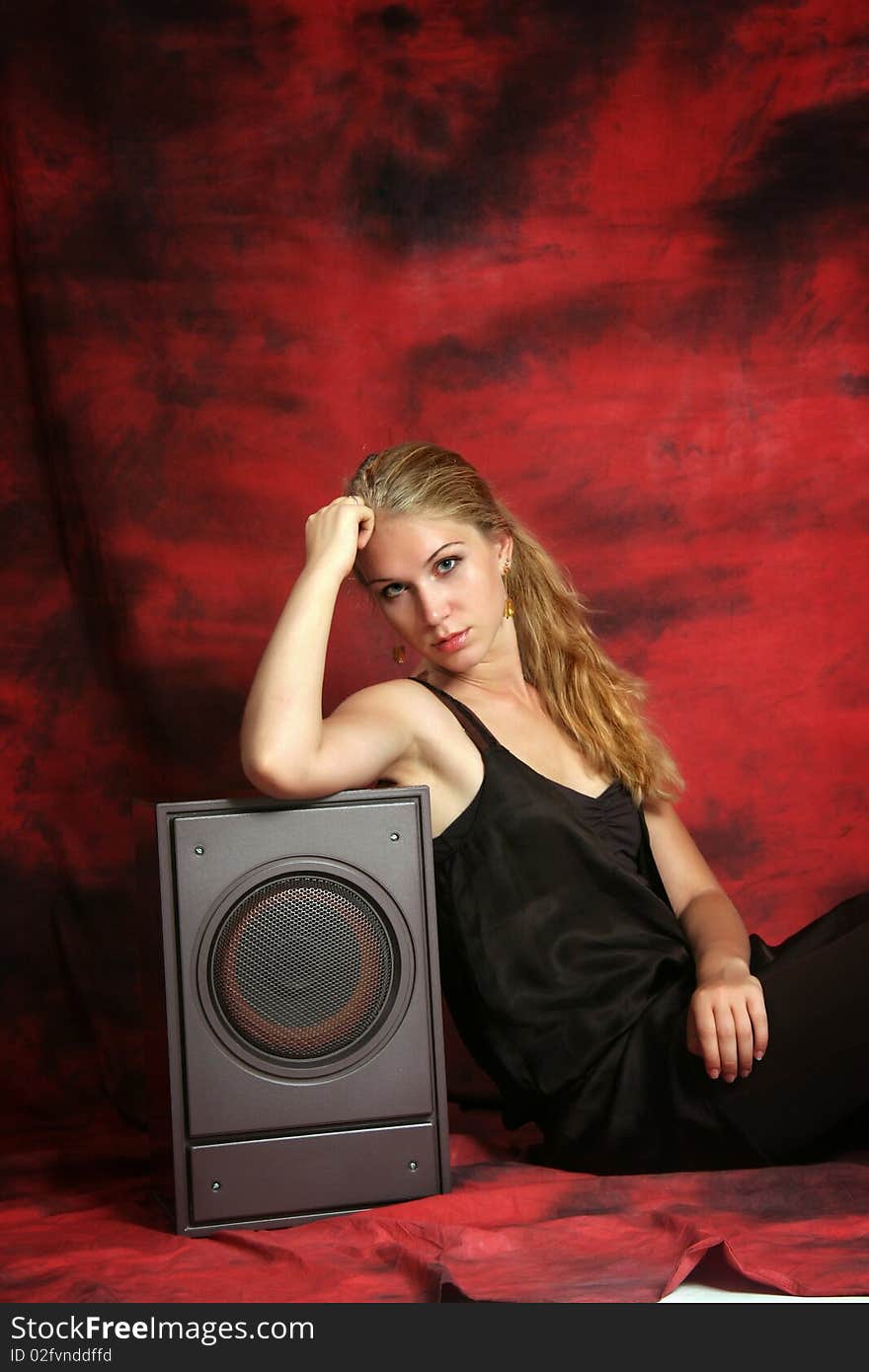 The girl with a subwoofer on a red background