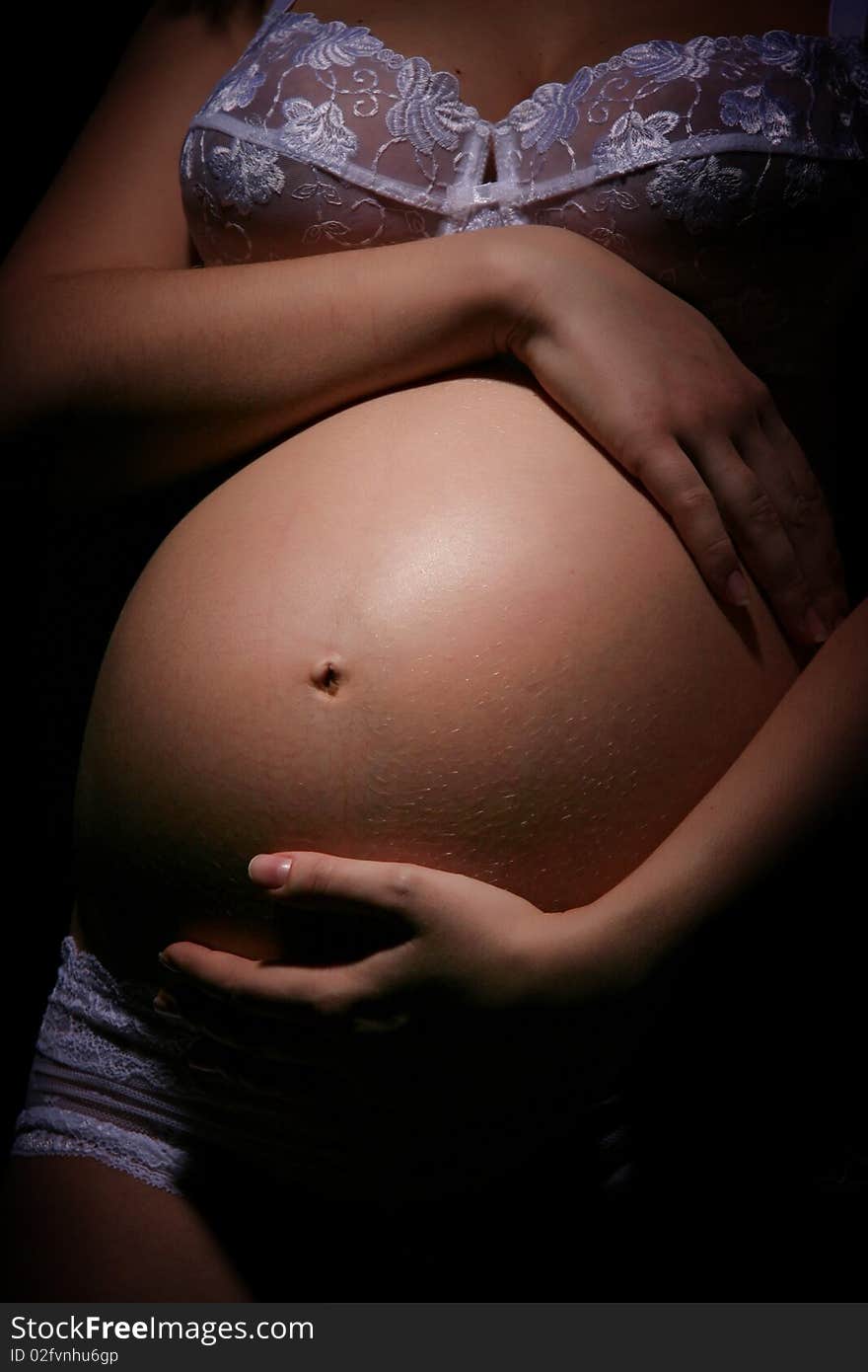 Stomach of the pregnant woman close up