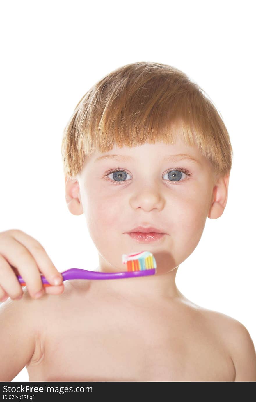 The little boy cleans a teeth on a white background. The little boy cleans a teeth on a white background