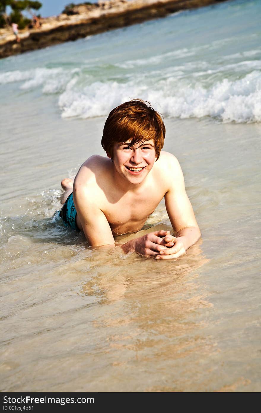 Happy boy with red hair is enjoying the beautiful beach. Happy boy with red hair is enjoying the beautiful beach