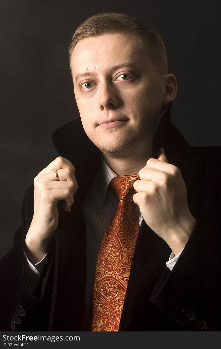 Young, elegant businessman, calm and confident face expression. Wearing shirt, tie and black coat. Young, elegant businessman, calm and confident face expression. Wearing shirt, tie and black coat.