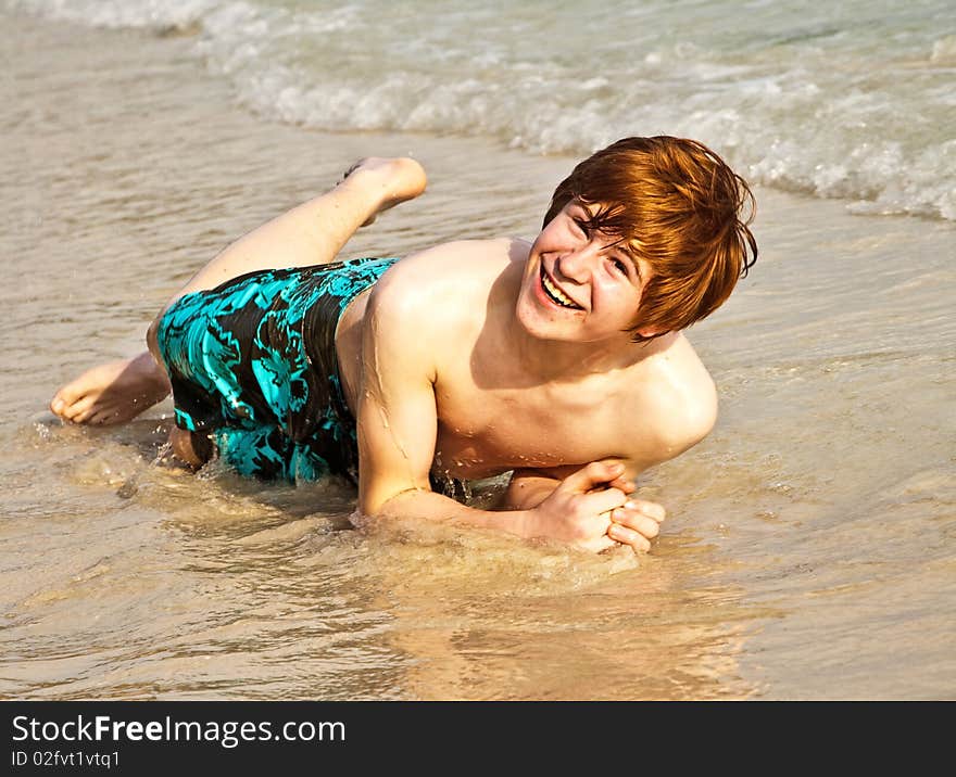 Happy boy with red hair is enjoying the beautiful beach. Happy boy with red hair is enjoying the beautiful beach