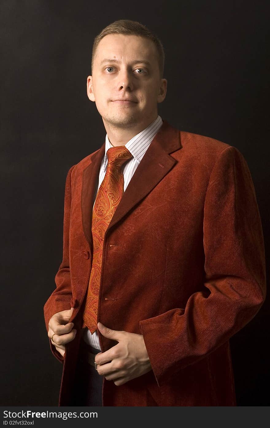 Young, elegant businessman, calm and confident face expression. Wearing shirt, tie and red suit. Young, elegant businessman, calm and confident face expression. Wearing shirt, tie and red suit.