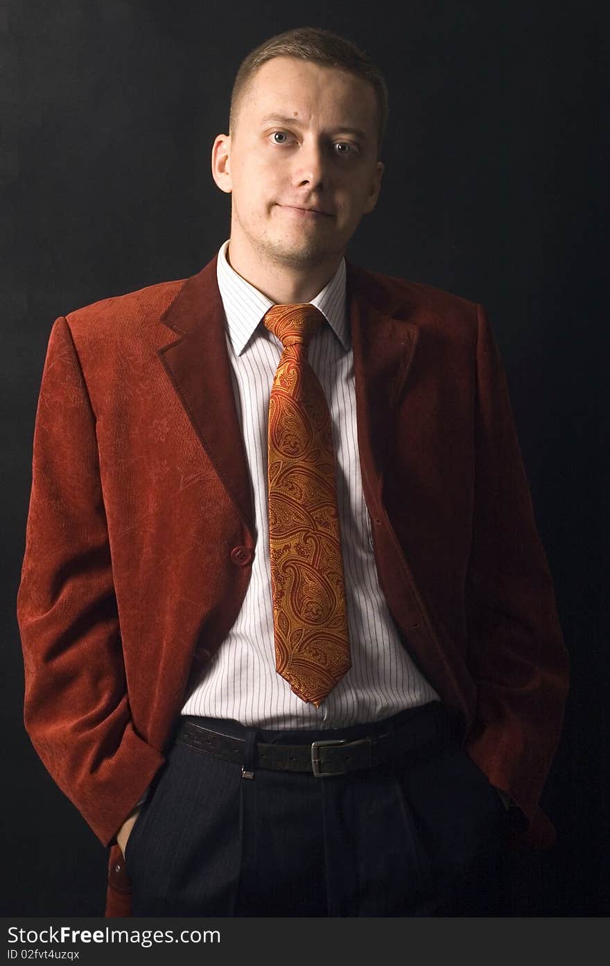 Young, elegant businessman, calm and confident face expression. Wearing shirt, tie and red suit. Young, elegant businessman, calm and confident face expression. Wearing shirt, tie and red suit.