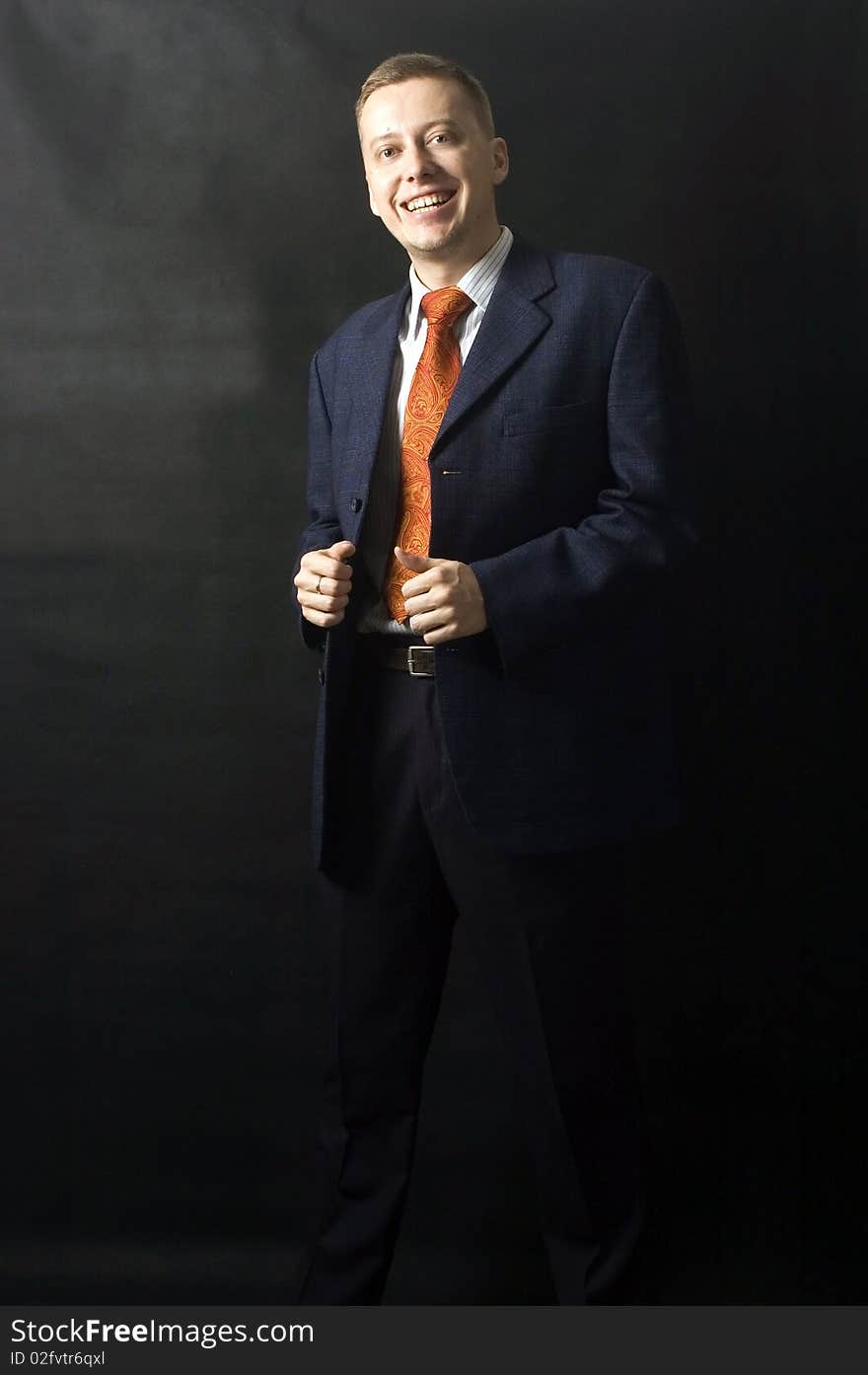 Happy businessman, black background