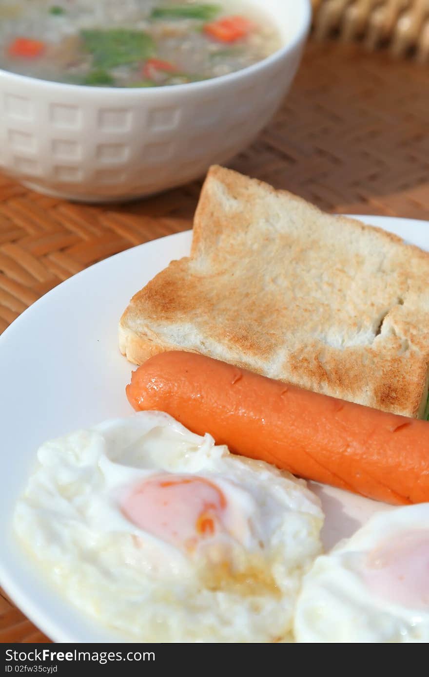 Delicious breakfast with bread sausage fried egg Cucumber and tomatoes