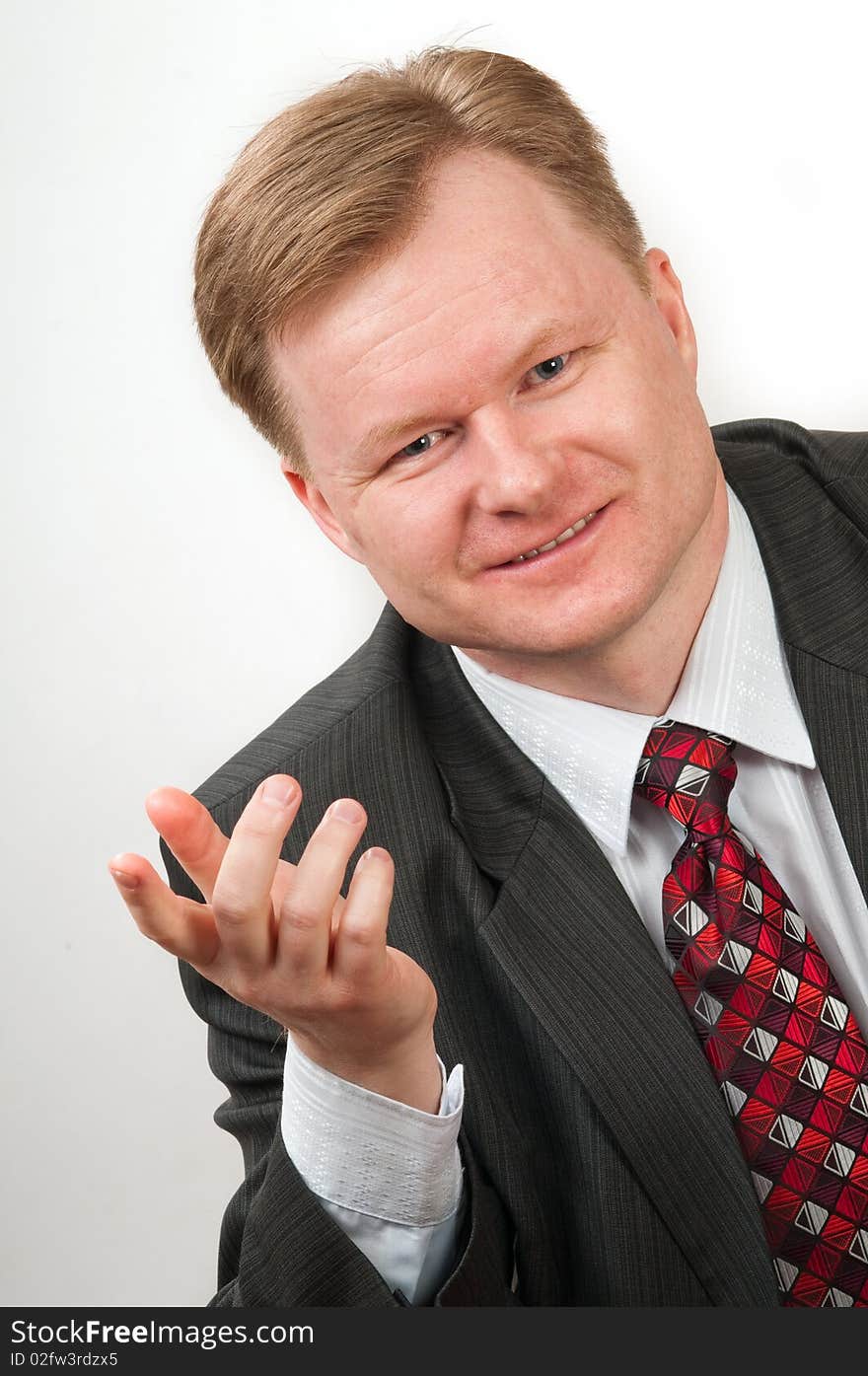 The man in a grey suit and a red tie in good mood. It the successful businessman. The man in a grey suit and a red tie in good mood. It the successful businessman.