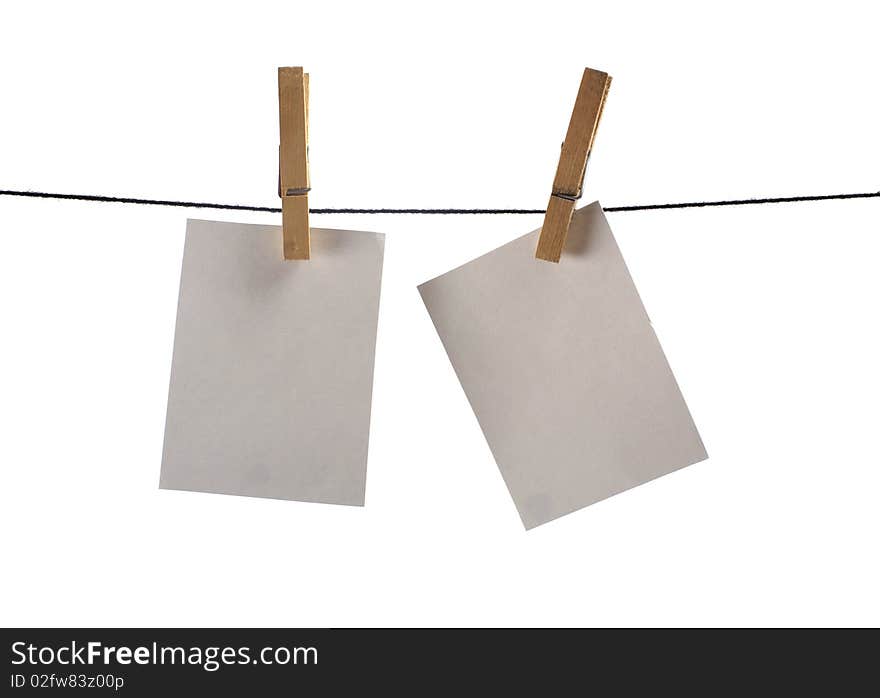 Photo paper hanging on several pins. Image isolated on white background. Photo paper hanging on several pins. Image isolated on white background.