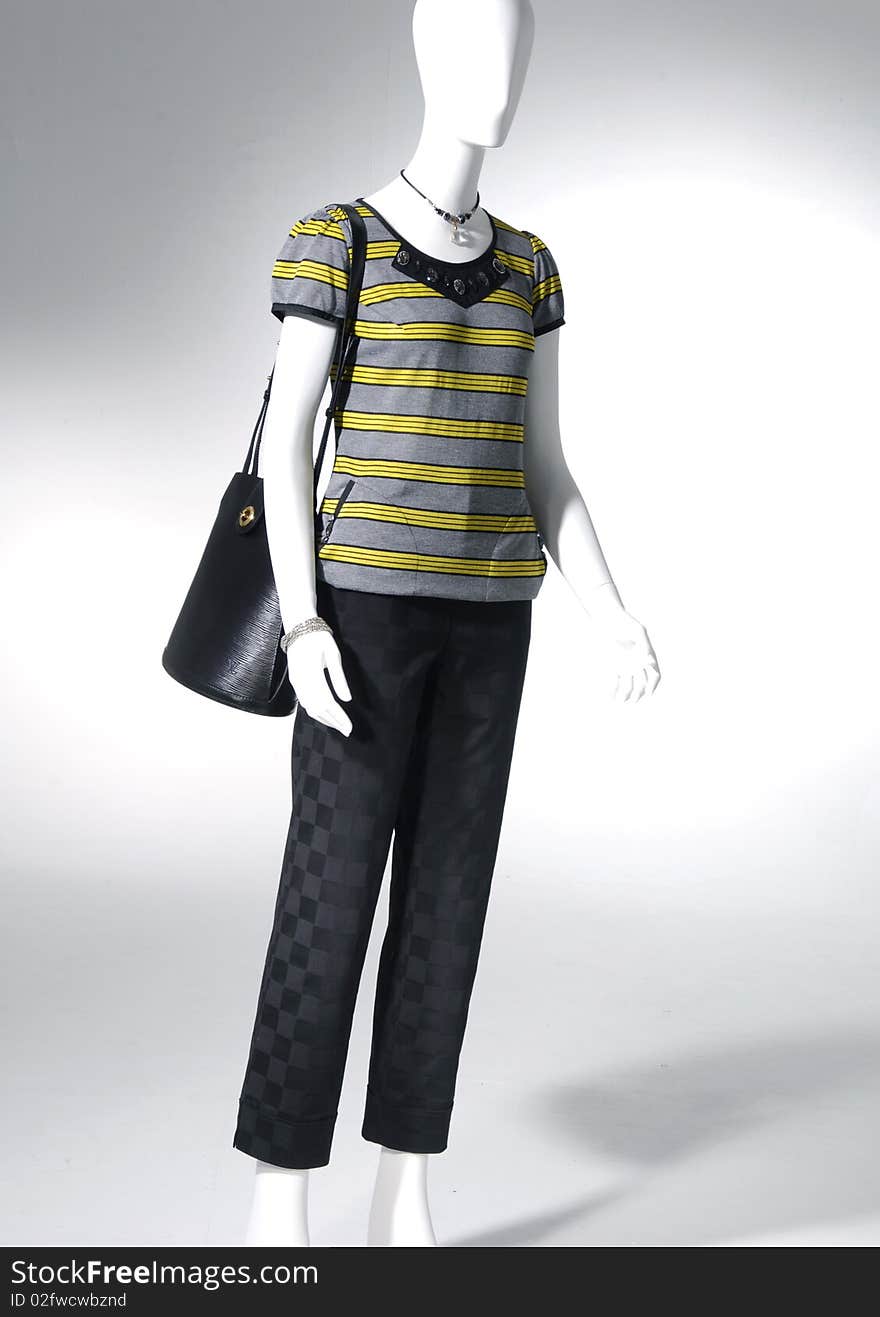 Fashion clothes on a mannequin holding bag. Fashion clothes on a mannequin holding bag