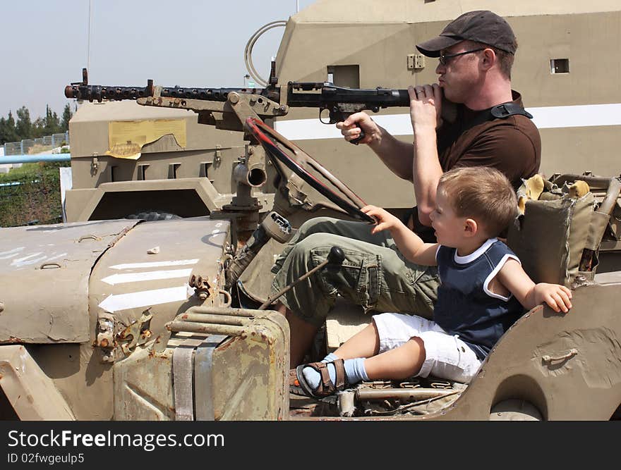 Men's game. Father and son at the Museum of tanks