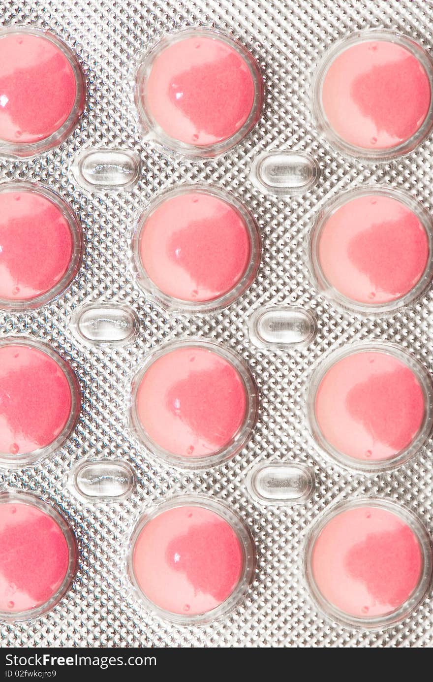 White round pills on the white isolated background