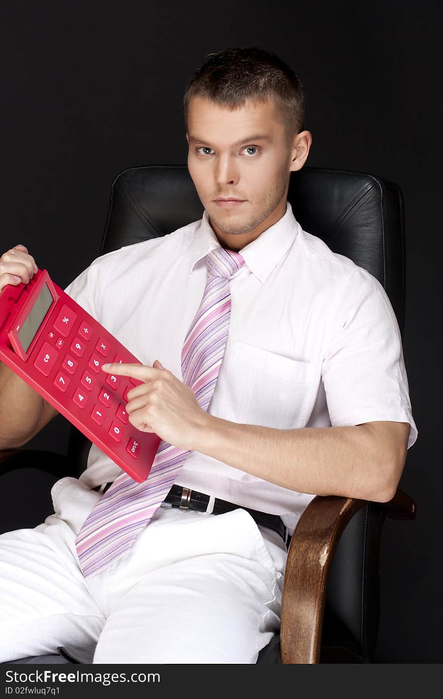 Handsome businessman with red calculator. Handsome businessman with red calculator