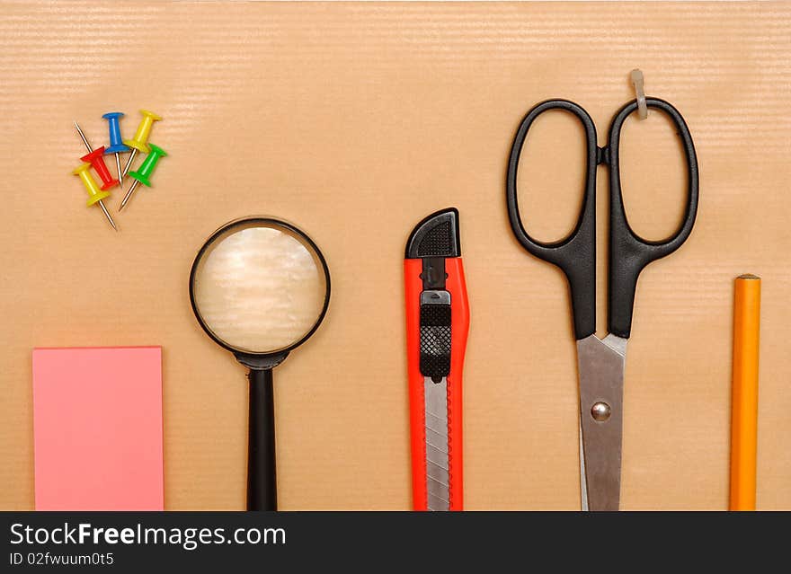 Office objects over brown paper background