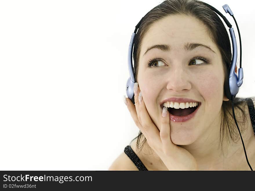 Happy Woman In Headphones Over White. Studio Shot