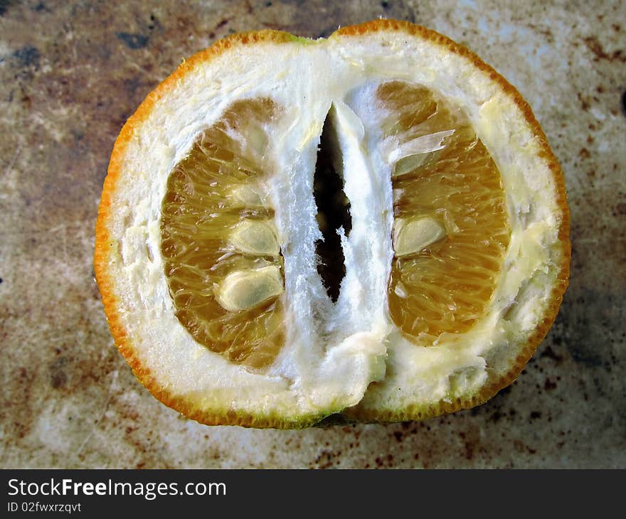 Half orange with seeds on a rough background