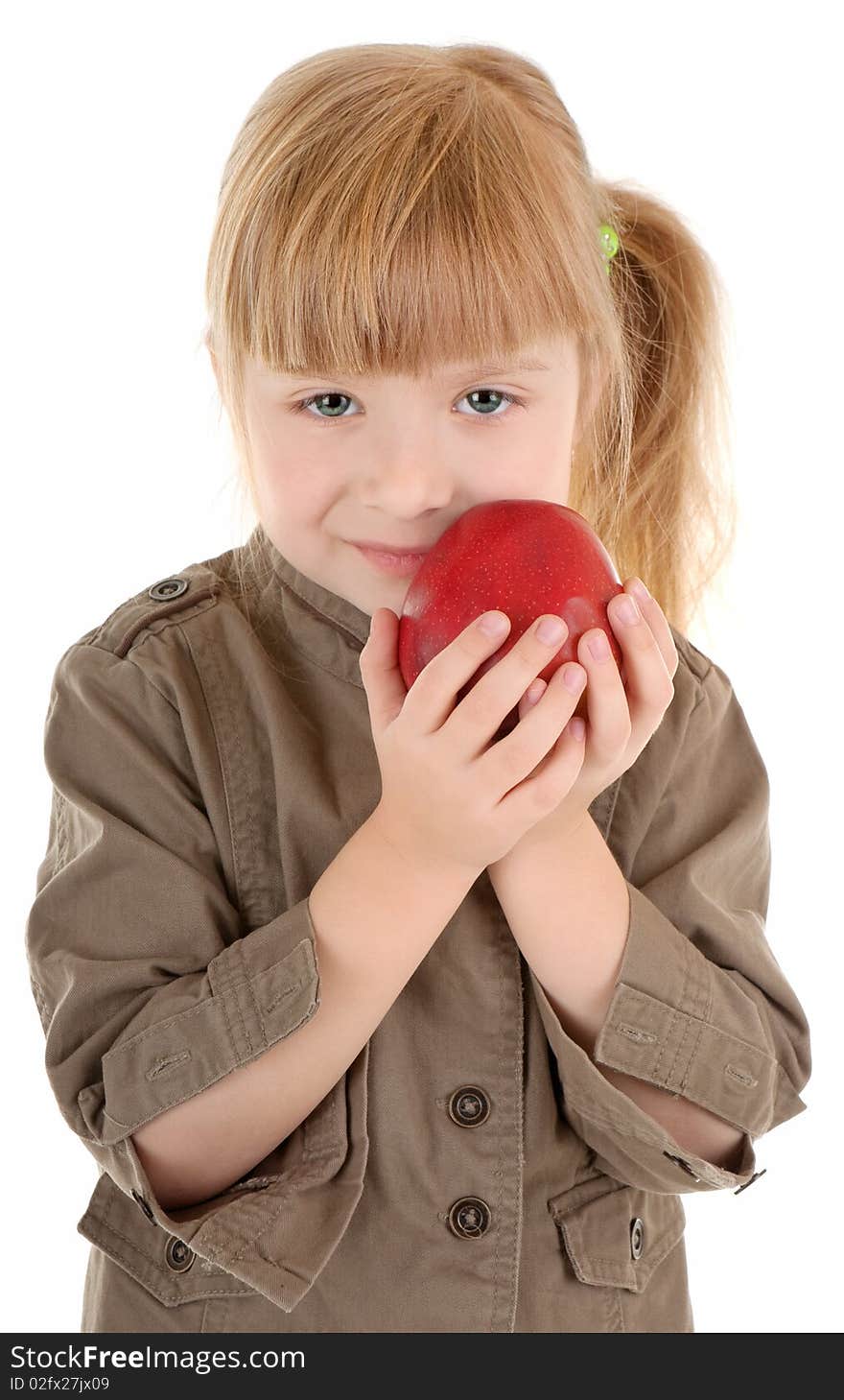 Friendly girl in walking clothing holds apple. Friendly girl in walking clothing holds apple