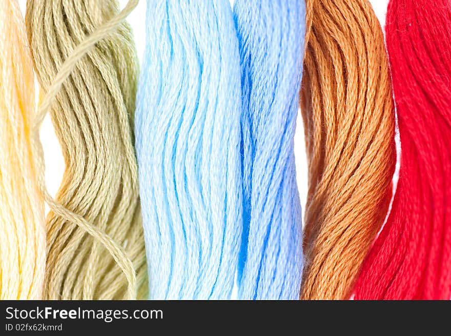 Coloured embroidery floss - isolated on white background.