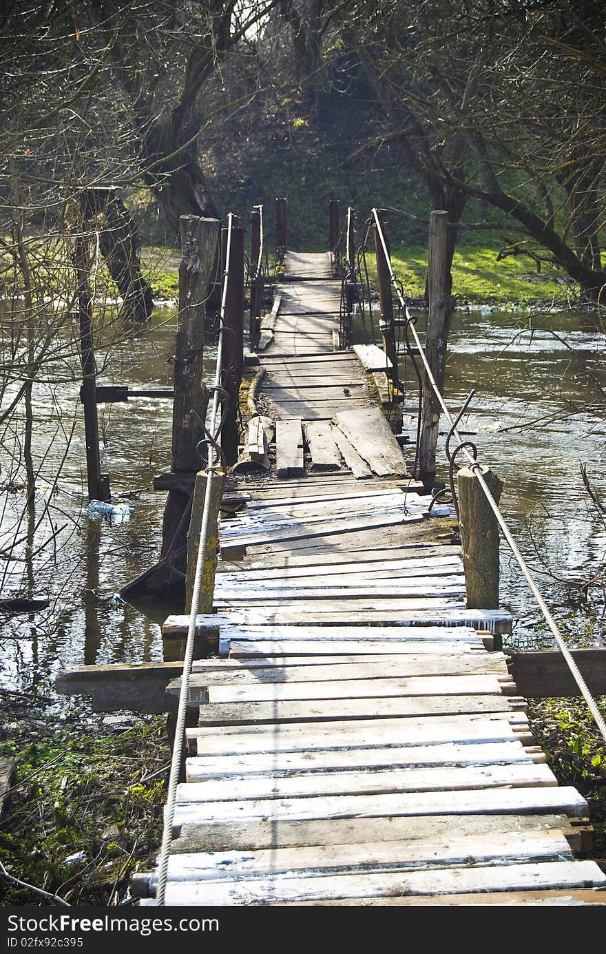 An old pendulous bridge connecting river shores