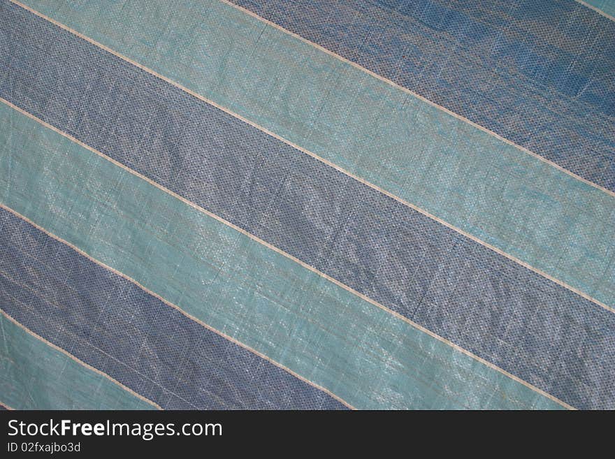 Striped blue and white background on a plastic sheet