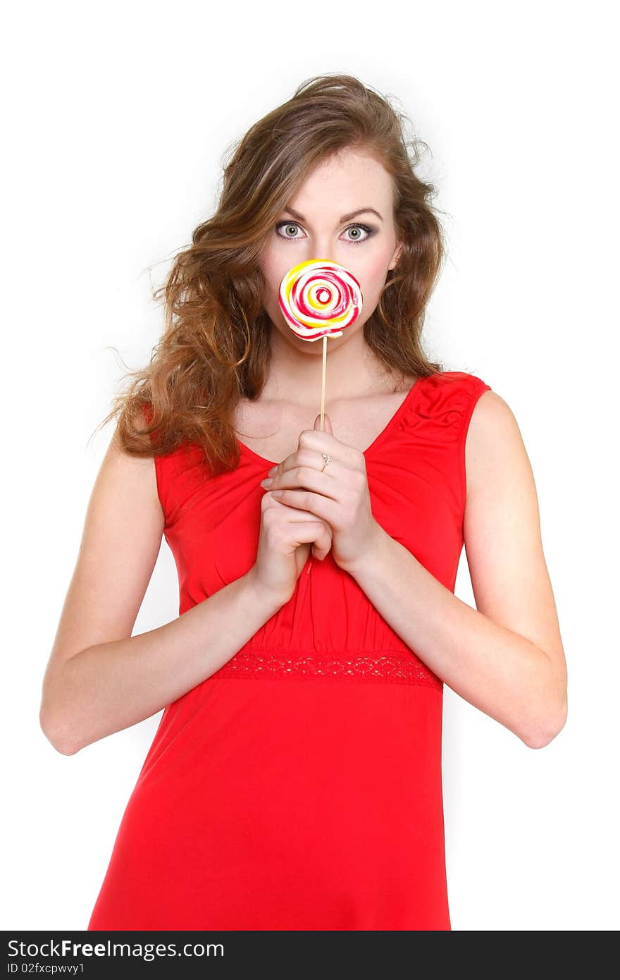 Portrait of attractive young woman with big lollipop over white