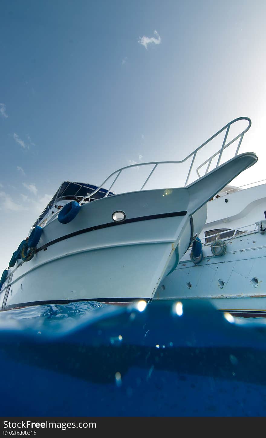 Low angle split view of the bow of a wooden dive boat. Low angle split view of the bow of a wooden dive boat.