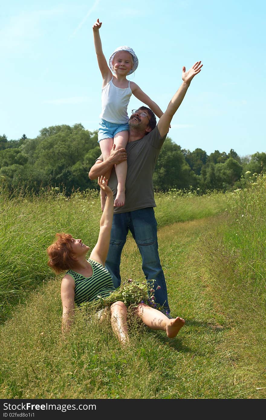 Parents With Daughter On Meadow