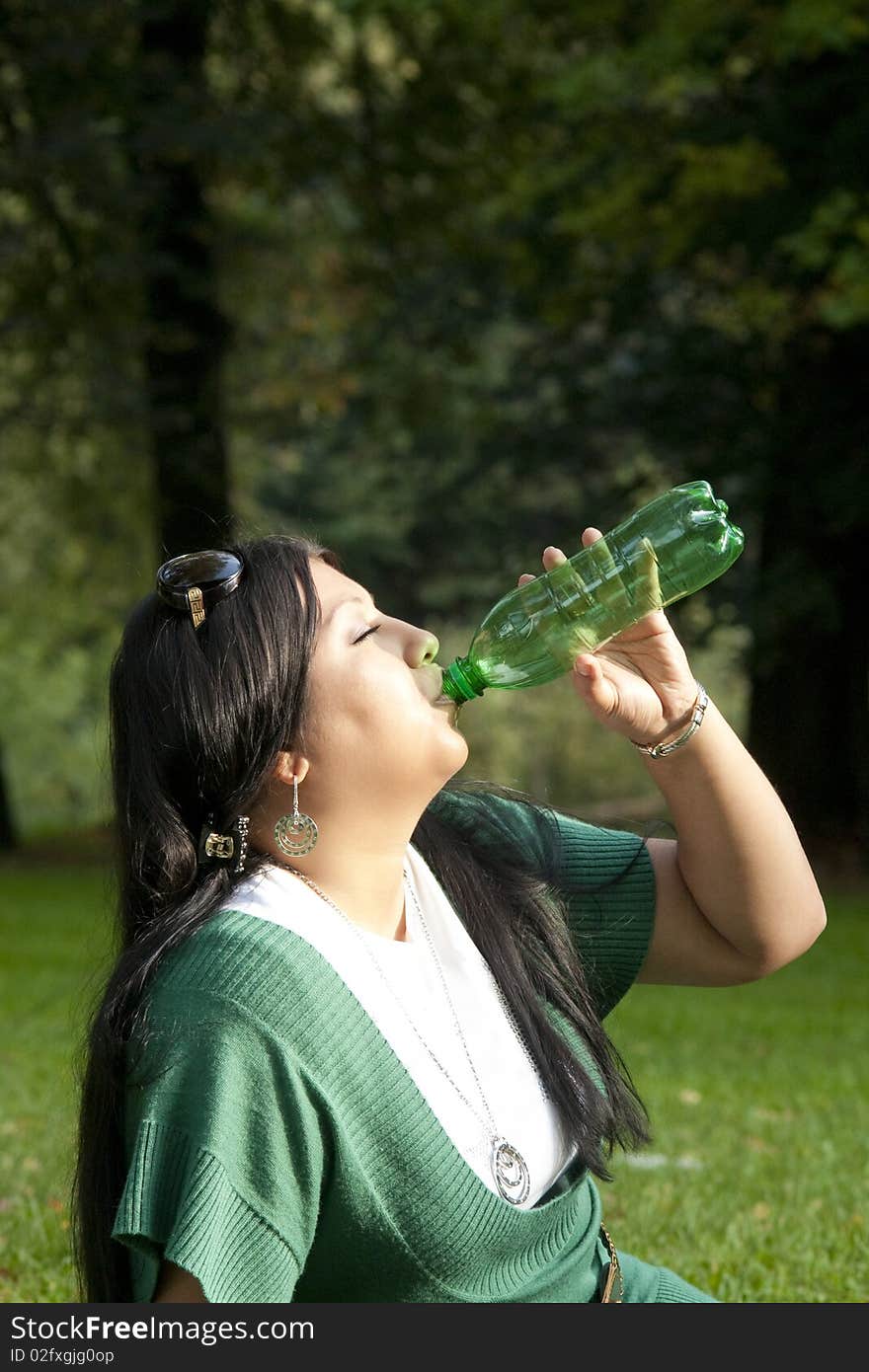 Young beauty brunette drinking water