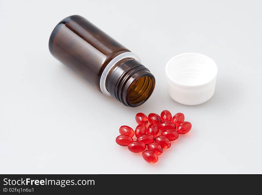 Little vial and red tablets