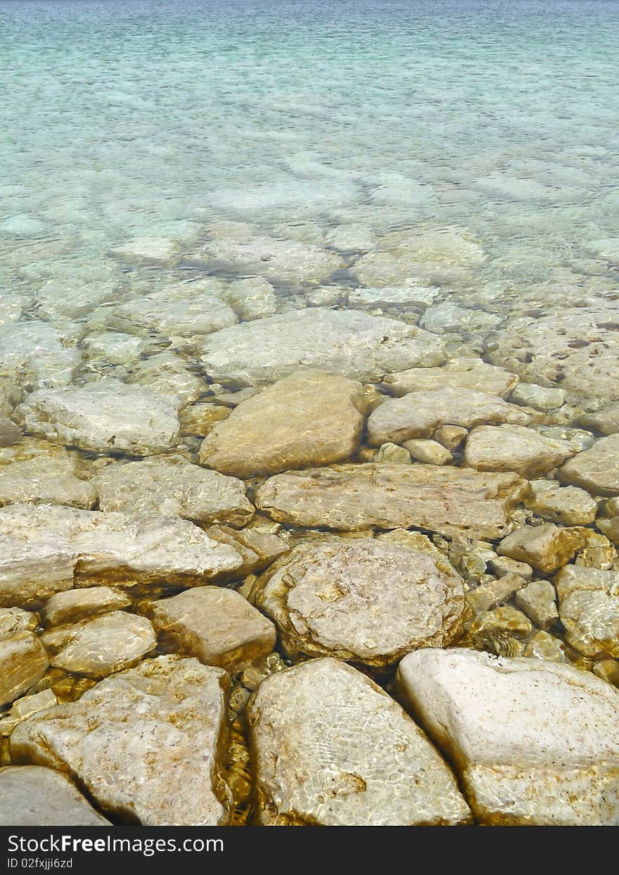 Clear waters with rocky bottom background