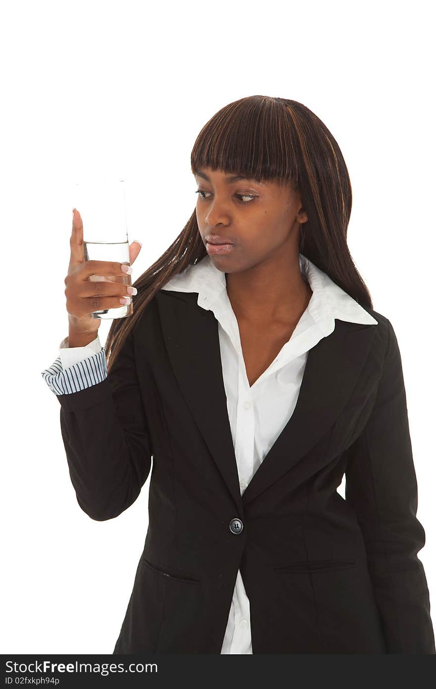 Young black female executive looking and inspecting glass of water. Young black female executive looking and inspecting glass of water