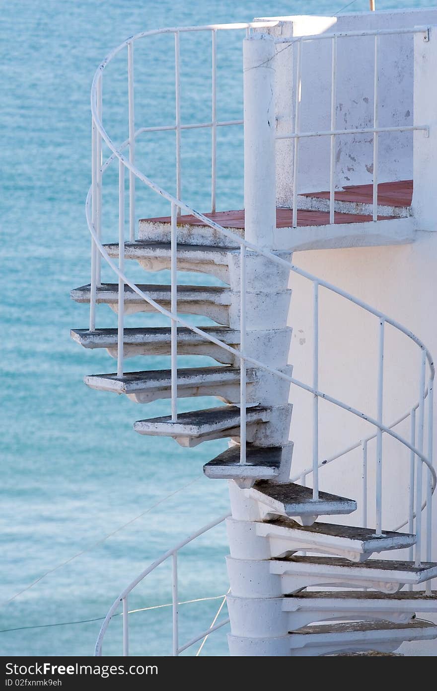 Spiral staircase on ocean background