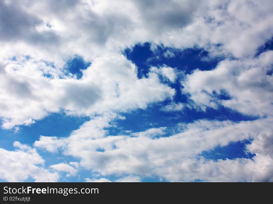 Deep blue sky with white and gray clouds