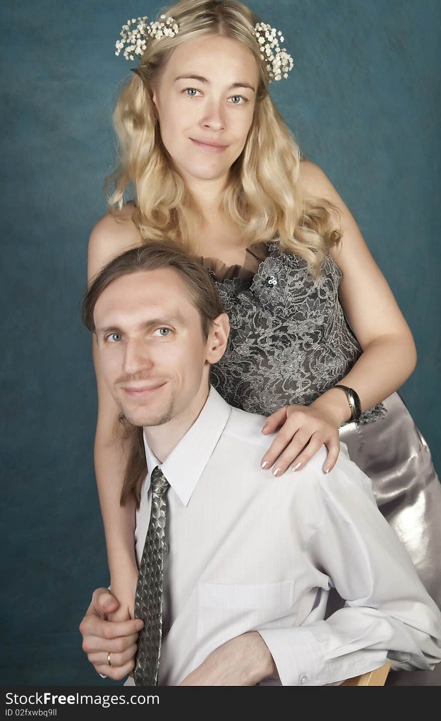 Newlyweds, studio portrait on blue background