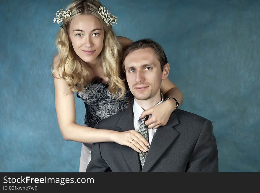 Happy bride and groom posing together in studio